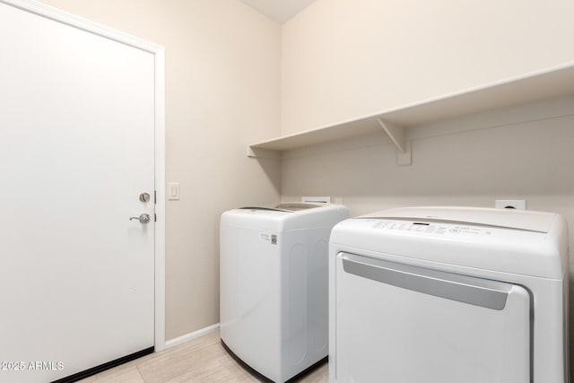 laundry area with laundry area, baseboards, and independent washer and dryer