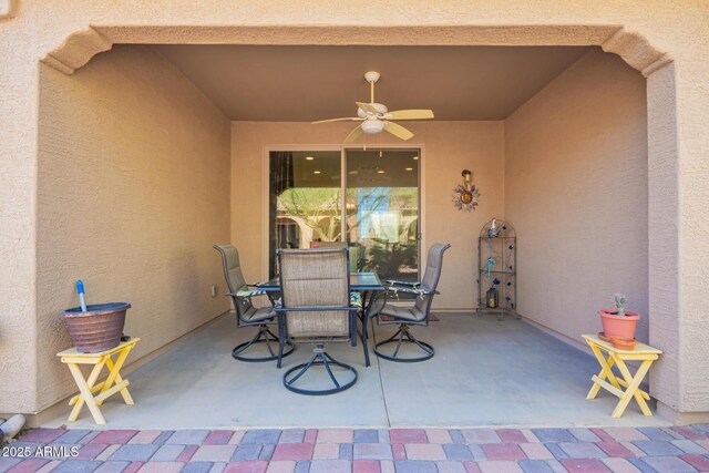 view of patio / terrace with ceiling fan and outdoor dining space