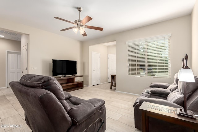 living area featuring visible vents, baseboards, and a ceiling fan