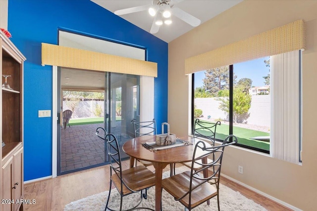 dining space featuring lofted ceiling, wood-type flooring, and ceiling fan