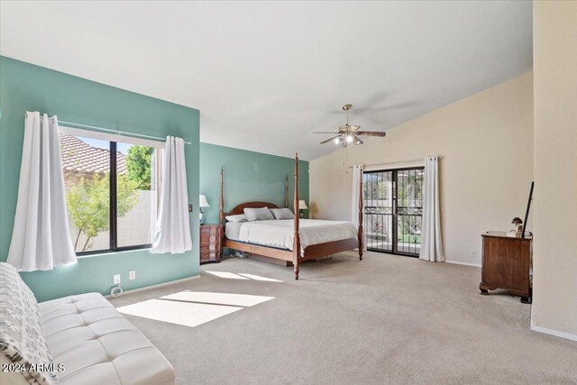 bedroom featuring ceiling fan, vaulted ceiling, multiple windows, and light colored carpet