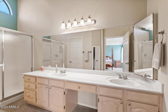 bathroom with vanity and a shower with shower door