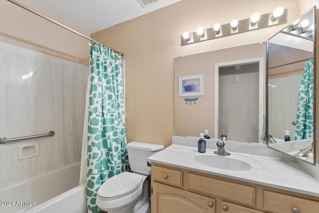 full bathroom with vanity, shower / tub combo with curtain, and toilet