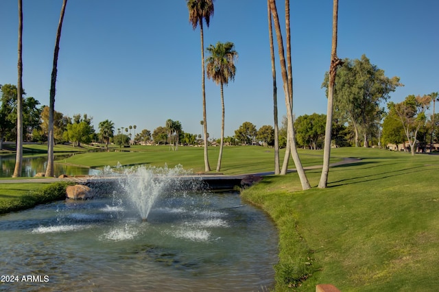 view of community with a yard and a water view