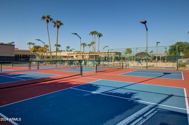 view of tennis court featuring basketball hoop