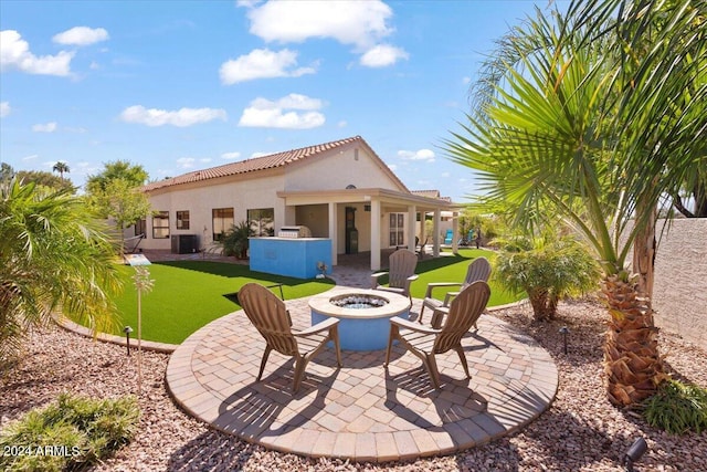 back of property featuring an outdoor fire pit, a patio area, central AC, and a yard