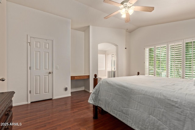 bedroom featuring arched walkways, dark wood finished floors, baseboards, lofted ceiling, and ceiling fan