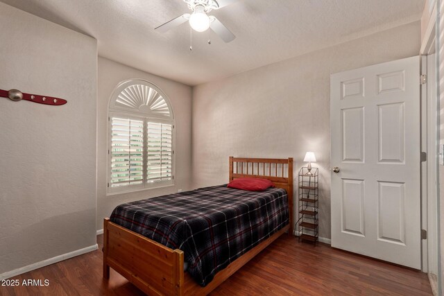 bedroom with wood finished floors, baseboards, and ceiling fan