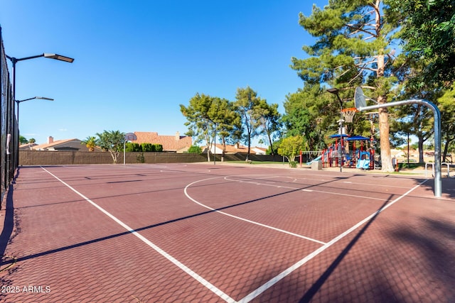 view of basketball court with community basketball court and fence