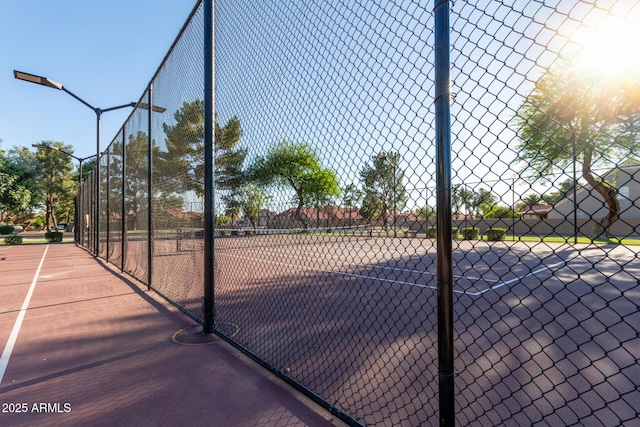 view of tennis court with fence