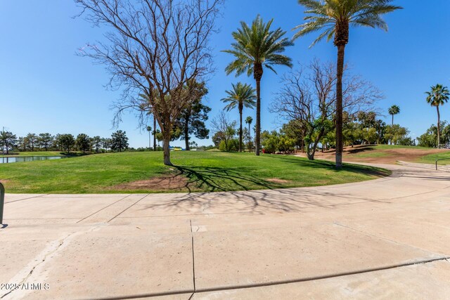 surrounding community featuring a water view and a yard