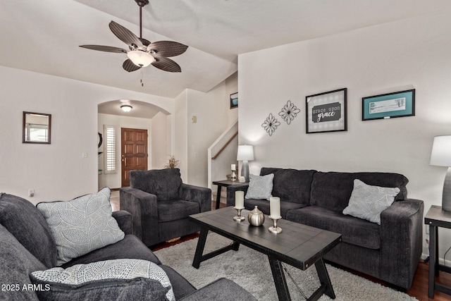 living room featuring arched walkways, ceiling fan, vaulted ceiling, and wood finished floors