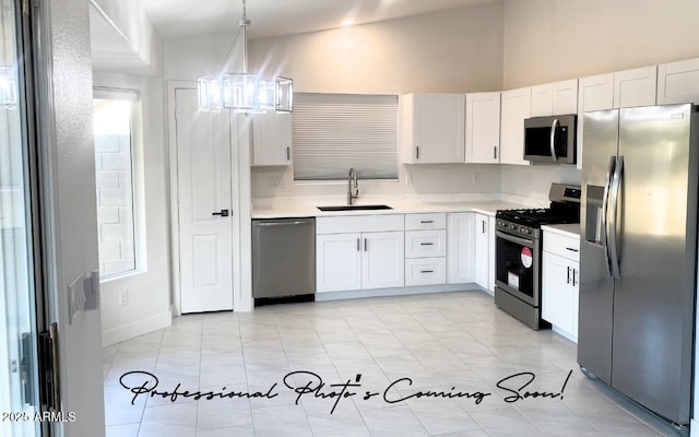 kitchen with an inviting chandelier, a sink, stainless steel appliances, light countertops, and white cabinetry