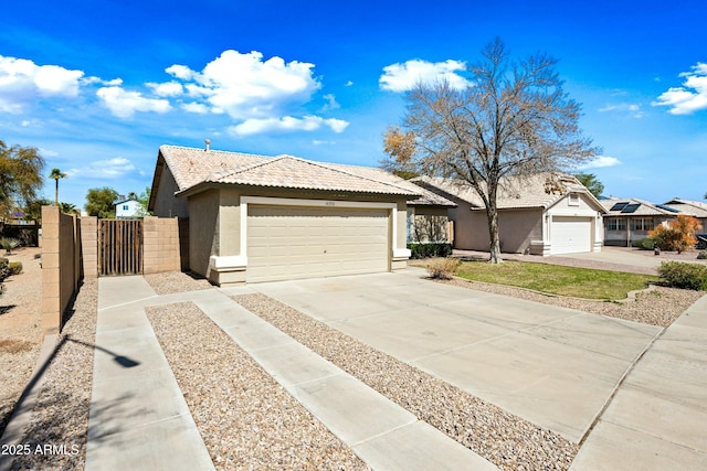 single story home with stucco siding, a tile roof, a garage, and a gate