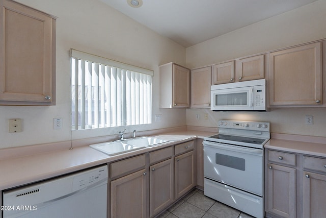 kitchen featuring light brown cabinets and white appliances