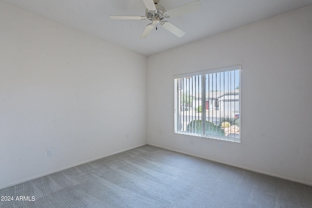 unfurnished room with ceiling fan and carpet