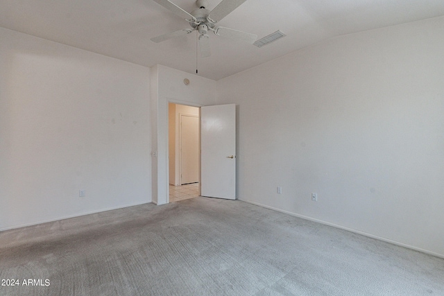 unfurnished room featuring light carpet, lofted ceiling, and ceiling fan