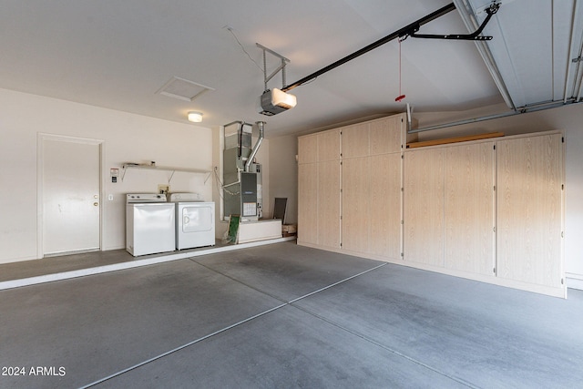 garage with a garage door opener, separate washer and dryer, and heating unit