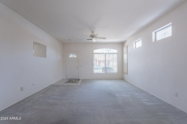 unfurnished living room with ceiling fan, carpet floors, and a healthy amount of sunlight