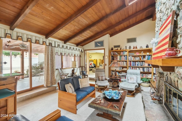 living area featuring beam ceiling, a stone fireplace, high vaulted ceiling, and wood ceiling