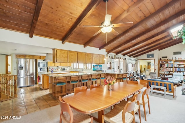 tiled dining area featuring ceiling fan, beam ceiling, wooden ceiling, and high vaulted ceiling