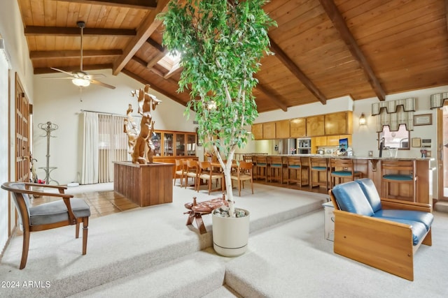 carpeted living room featuring beamed ceiling, ceiling fan, wood ceiling, and high vaulted ceiling