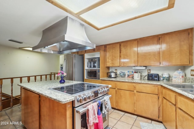 kitchen featuring sink, light tile patterned flooring, island exhaust hood, a kitchen island, and appliances with stainless steel finishes