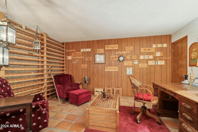 tiled home office with a textured ceiling and wooden walls