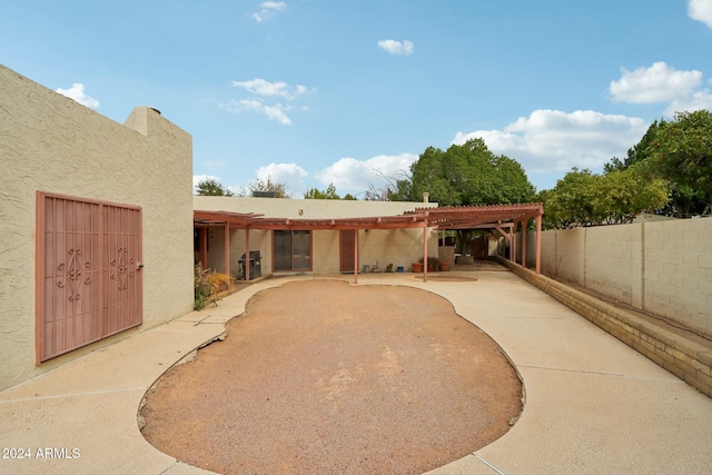 rear view of house featuring a patio area and a pergola