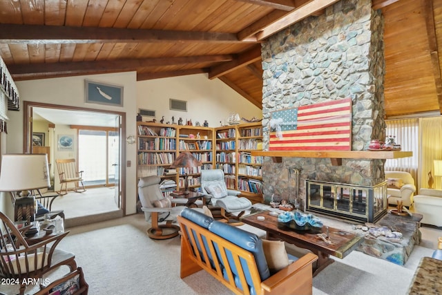 carpeted living room with beamed ceiling, high vaulted ceiling, a stone fireplace, and wood ceiling