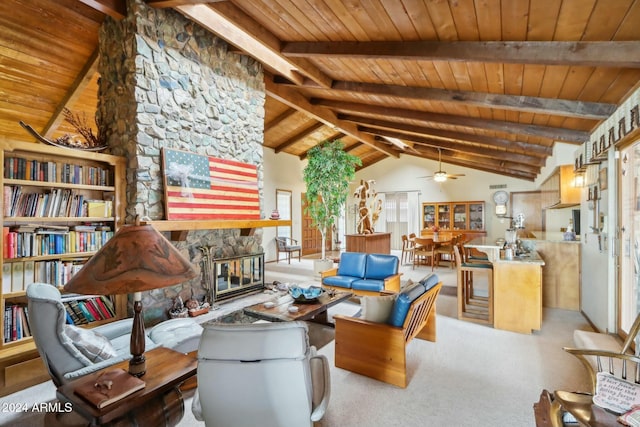 sitting room with ceiling fan, wooden ceiling, beamed ceiling, high vaulted ceiling, and a fireplace