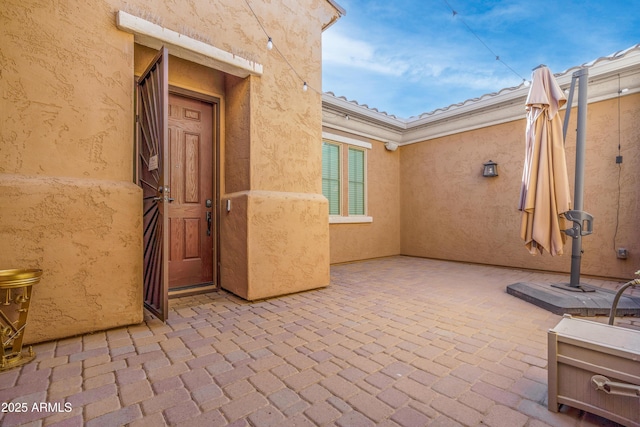 doorway to property with a patio