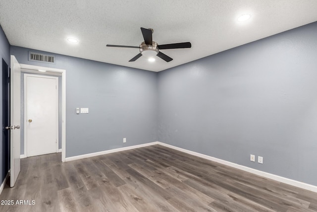 spare room with hardwood / wood-style flooring, a textured ceiling, and ceiling fan