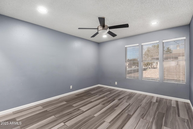 unfurnished room with a textured ceiling, ceiling fan, and hardwood / wood-style floors