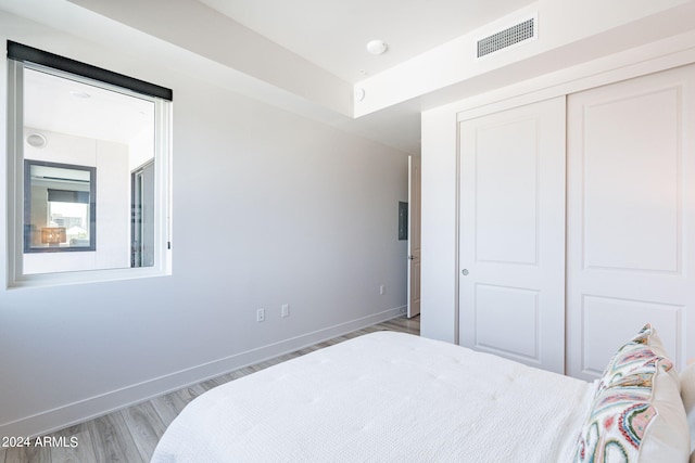 bedroom with hardwood / wood-style flooring and a closet