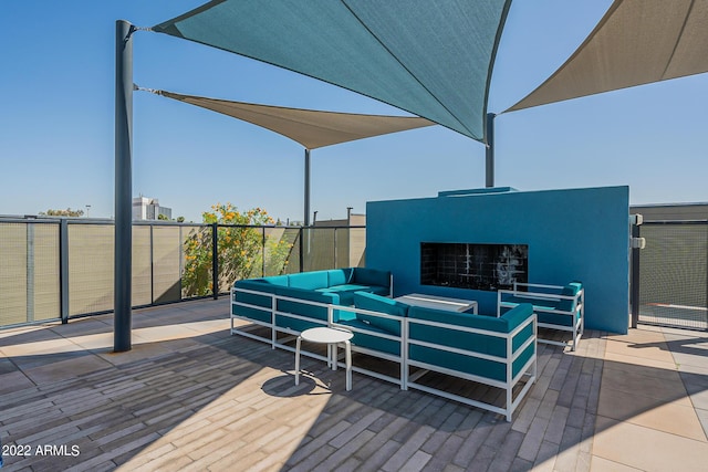 view of patio / terrace with an outdoor living space with a fireplace