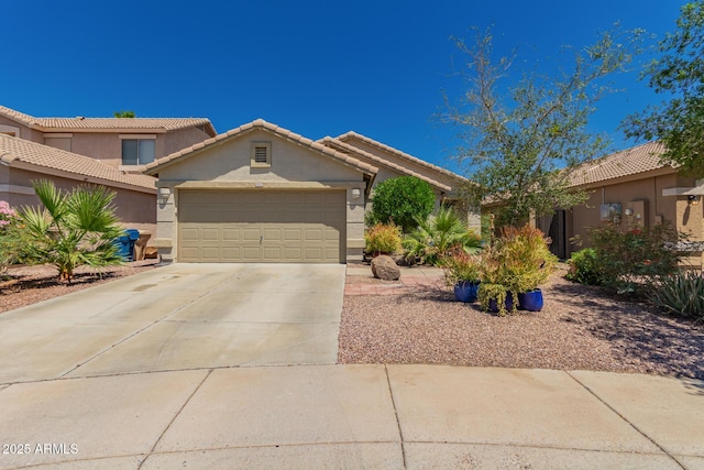 6031 N Milano Ct, Litchfield Park, AZ 85340 - view of front of house featuring stucco siding, an attached garage, driveway, and a tiled roof