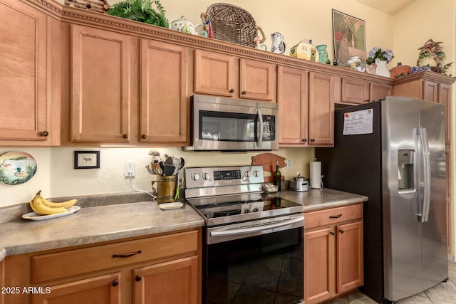 6031 N Milano Ct, Litchfield Park, AZ 85340 - kitchen featuring appliances with stainless steel finishes, brown cabinetry, and light tile patterned floors
