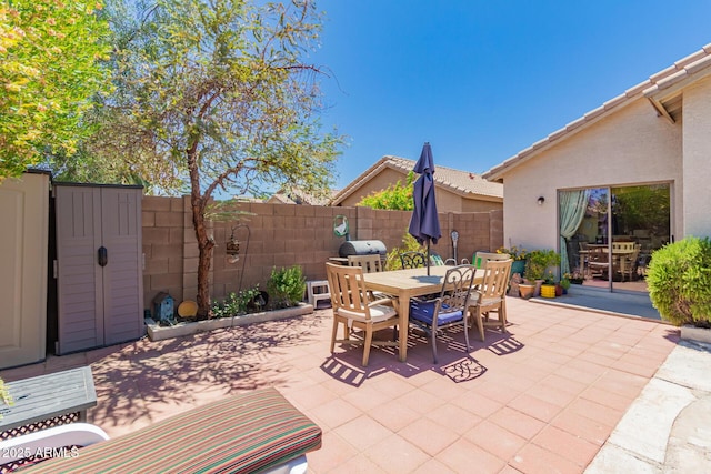 6031 N Milano Ct, Litchfield Park, AZ 85340 - view of patio / terrace with outdoor dining space, fence, and a grill