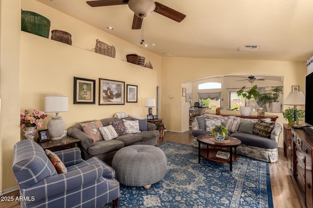 6031 N Milano Ct, Litchfield Park, AZ 85340 - living room with a ceiling fan, arched walkways, wood finished floors, and baseboards