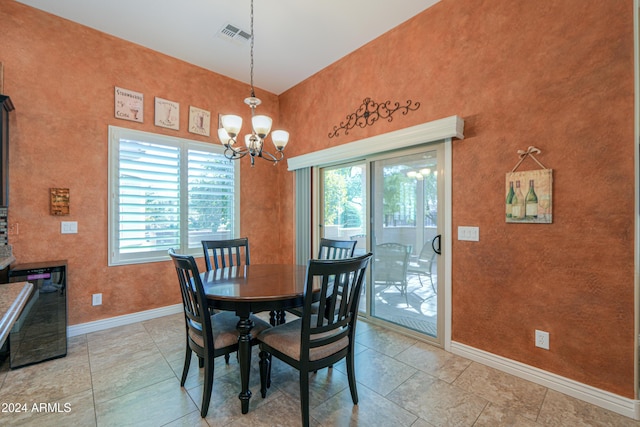 tiled dining space with wine cooler and a notable chandelier