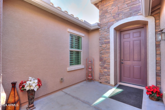 property entrance with a patio