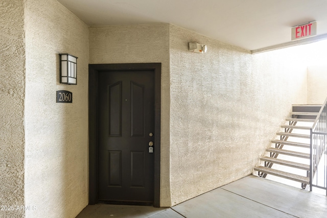 entrance to property featuring stucco siding