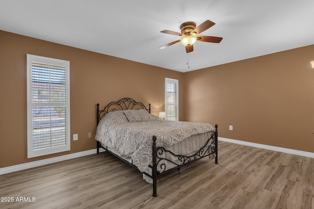 bedroom with hardwood / wood-style flooring and ceiling fan