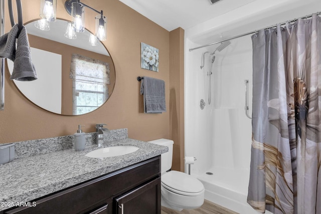 bathroom featuring vanity, toilet, and curtained shower