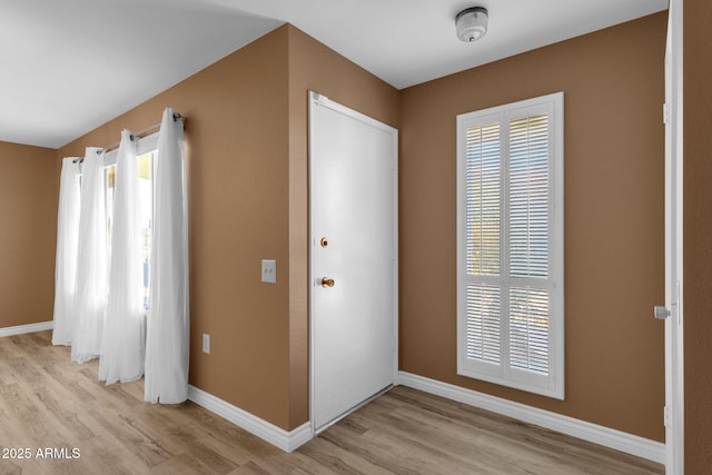 entryway with light hardwood / wood-style floors and a healthy amount of sunlight