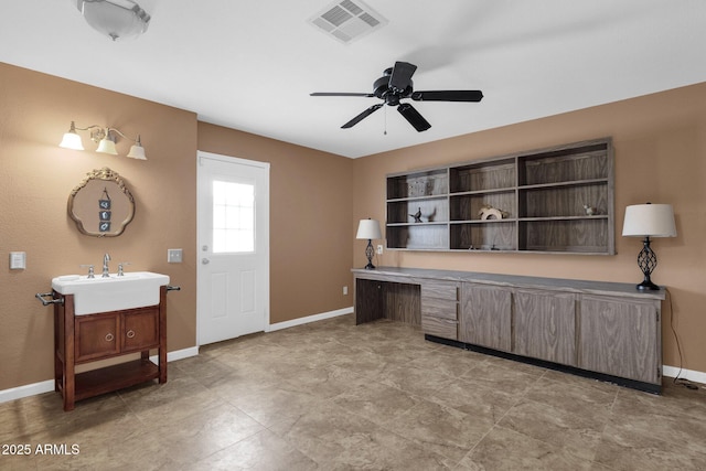 office space featuring ceiling fan and sink