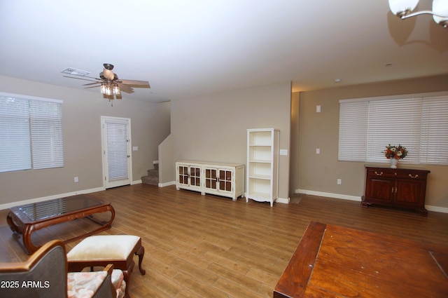 2150 W Alameda Rd Unit 1109, Phoenix, AZ 85085 - living room featuring stairway, baseboards, wood finished floors, and a ceiling fan
