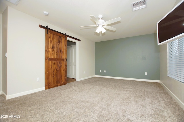 2150 W Alameda Rd Unit 1109, Phoenix, AZ 85085 - unfurnished bedroom with carpet floors, a barn door, baseboards, and ceiling fan