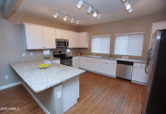 2150 W Alameda Rd Unit 1109, Phoenix, AZ 85085 - kitchen featuring appliances with stainless steel finishes, a peninsula, a sink, white cabinets, and track lighting
